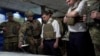 UKRAINE -- Ukrainian President Volodymyr Zelenskiy, center, listens to a serviceman as he visits the war-hit Donetsk region, October 14, 2019