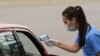 Kosovo - A nurse checking body temperature of people crossing the border between Kosovo and Albania - COVID-19