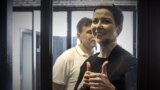 BELARUS -- Belarusian opposition activists Maryya Kalesnikava, foreground, and Maksim Znak, behind her, attend a court hearing in Minsk, August 4, 2021