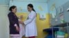 Kyrgyzstan -- a maternity nurse Sahida Kydyraliyeva and a pregnant woman in a clinic on May 2, 2018